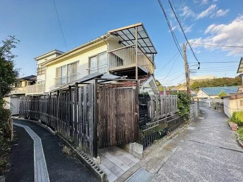 A property consisting of two buildings: a two-story residence and a three-story warehouse and residence set.