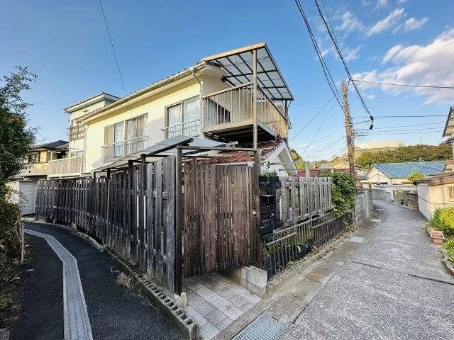 A property consisting of two buildings: a two-story residence and a three-story warehouse and residence set.