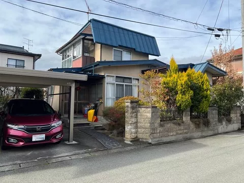 House with carport parking, wide engawa, and garden