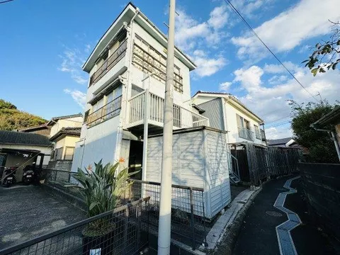 A property consisting of two buildings: a two-story residence and a three-story warehouse and residence set. - Image 2