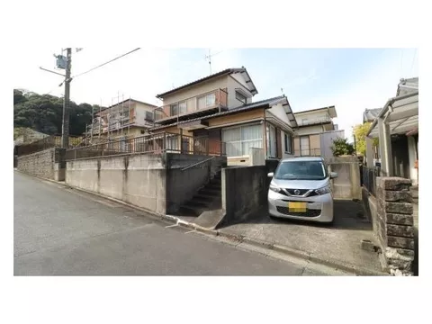 A detached house located in a quiet residential area on a hill