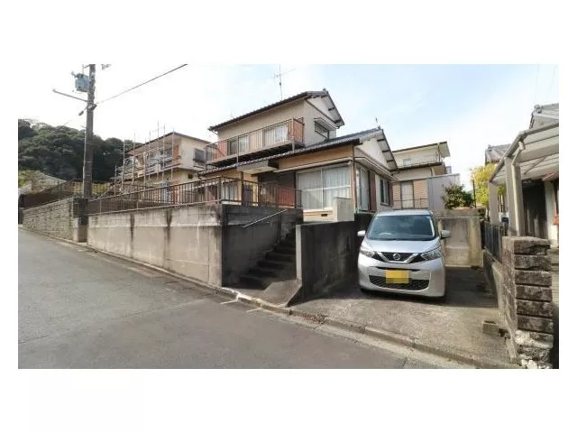 A detached house located in a quiet residential area on a hill