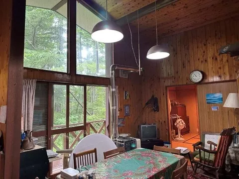 The living room has two sides of natural light, and all water areas have windows, giving a bright impression of the house. - Image 3