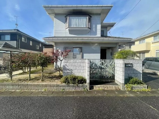 A detached house with a garden in a quiet residential area.